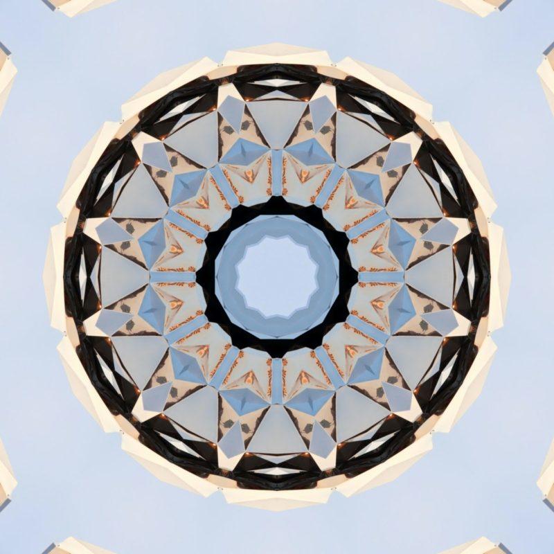 An NFT of a kaleidoscope of beige, sky blue and black.