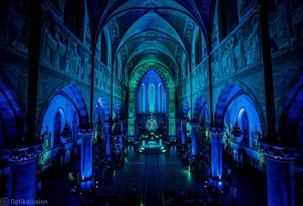 A blue lit large cathedral.