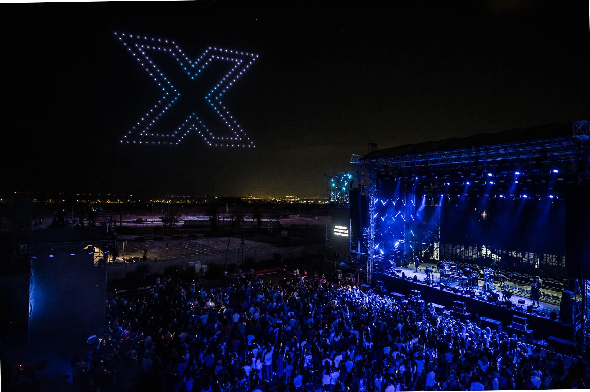 Drones that paint a virtual X in the air with lights at the Together X Event by Battle Royal Studios