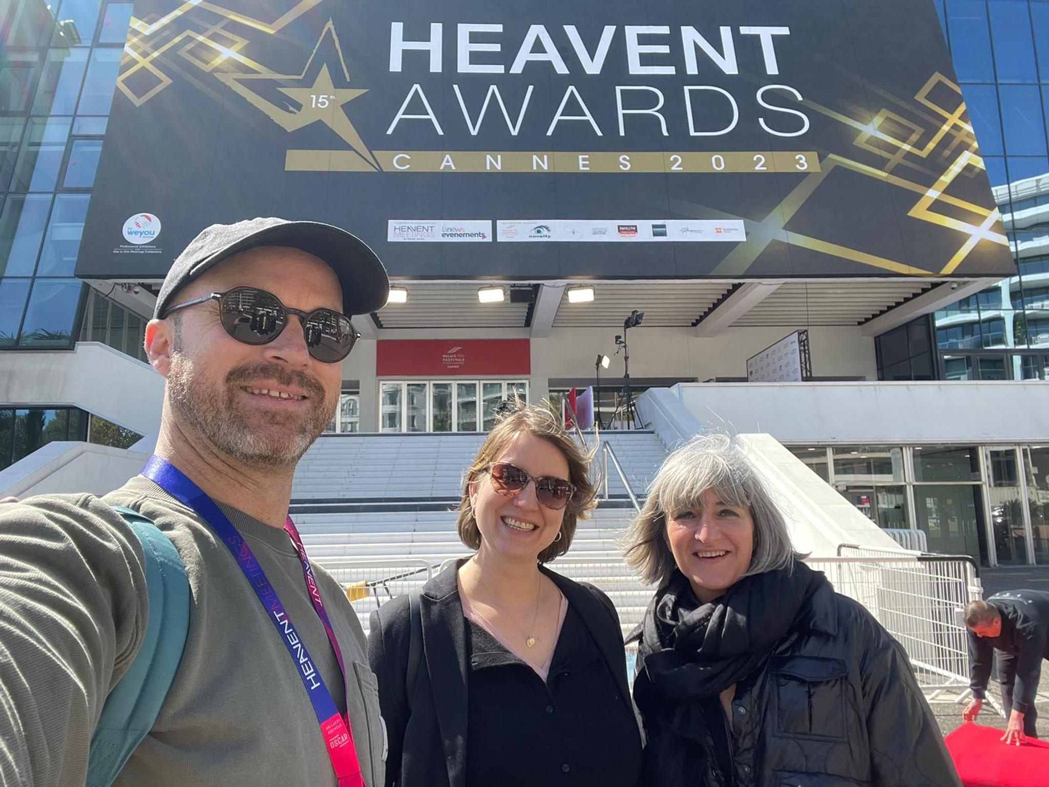 Three Battle Royal Studios Team members in front of the Heavent Awards entry