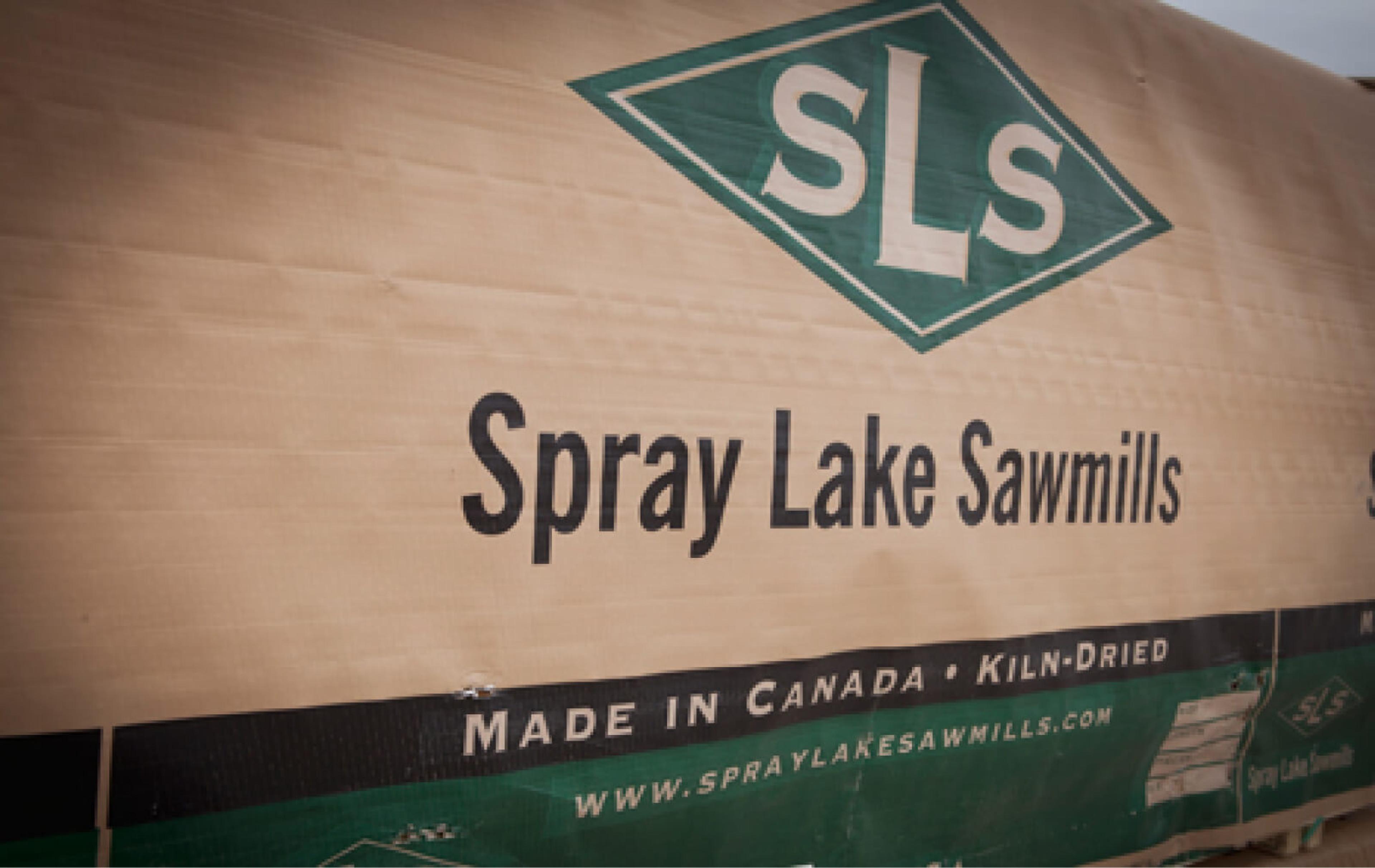 Banner signage reading 'Spray Lake Sawmills: Made in Canada - Kiln-Dried'