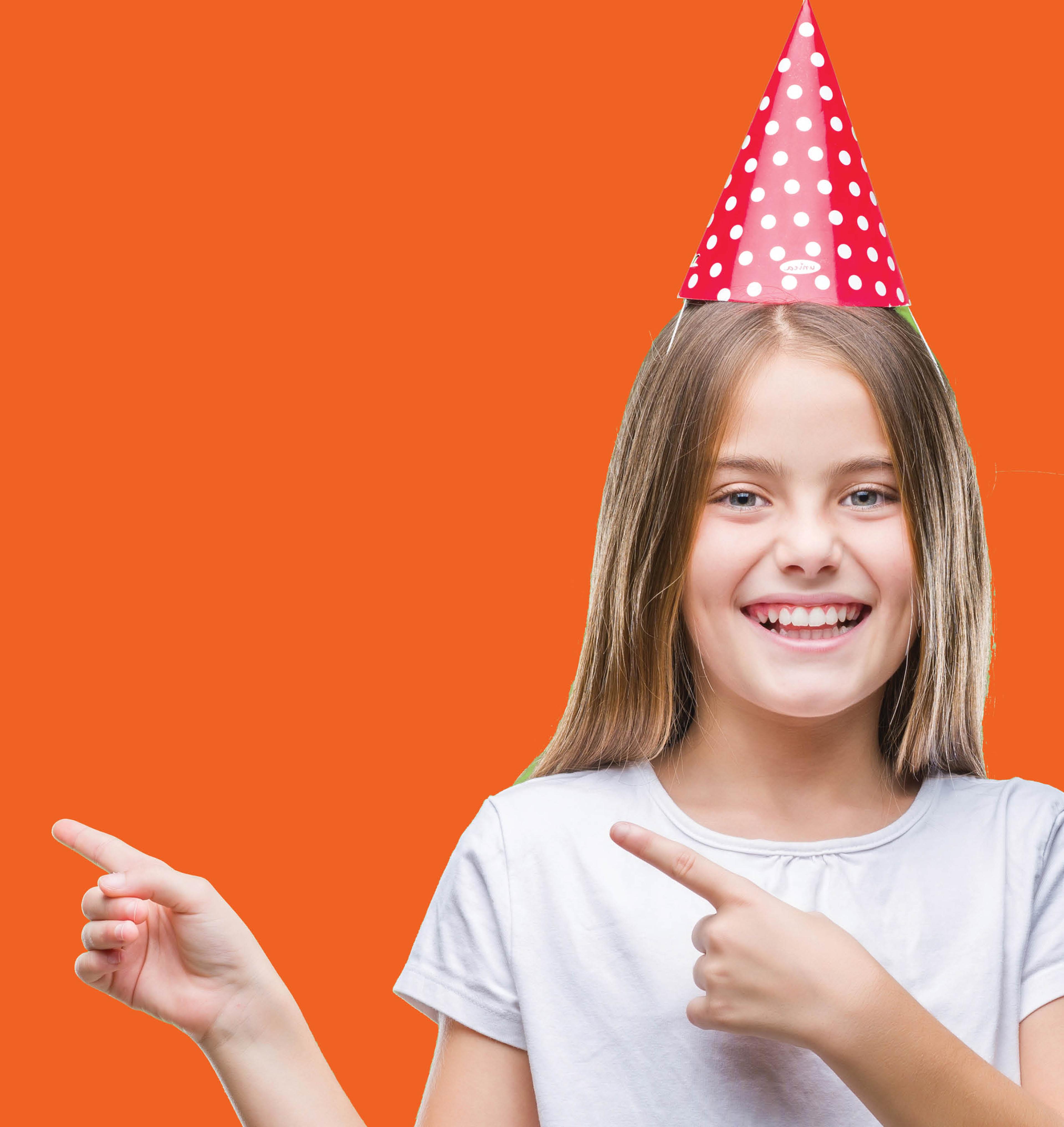 Smiling female child wearing a party hat on a bright orange background.
