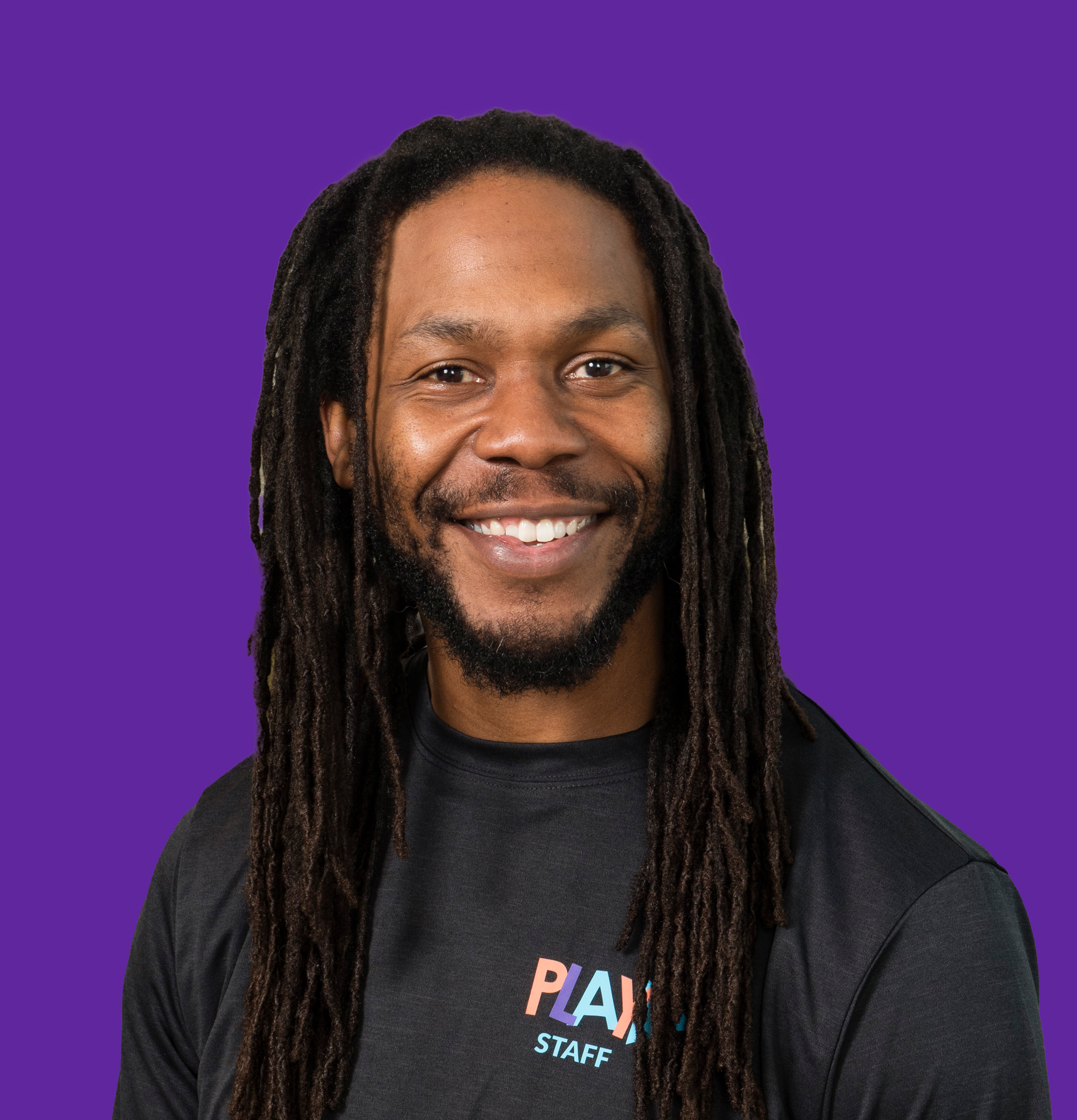 Head shot of Curtis on a perfect purple background.