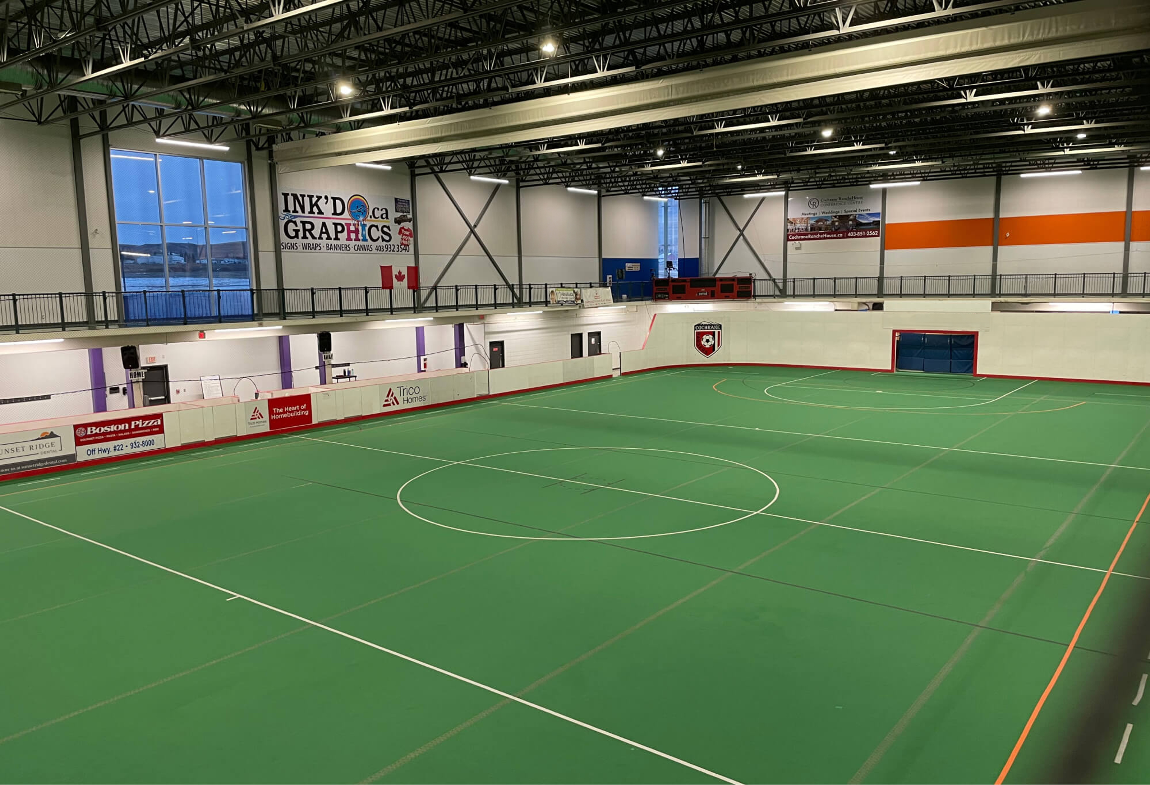 Upper level view looking down onto empty indoor soccer field at the SLS Centre.
