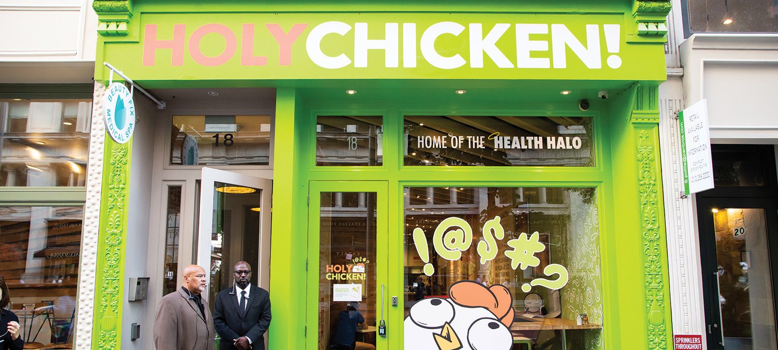 the outside of a chicken restaurant with the words at the top, "HOLY CHICKEN!"