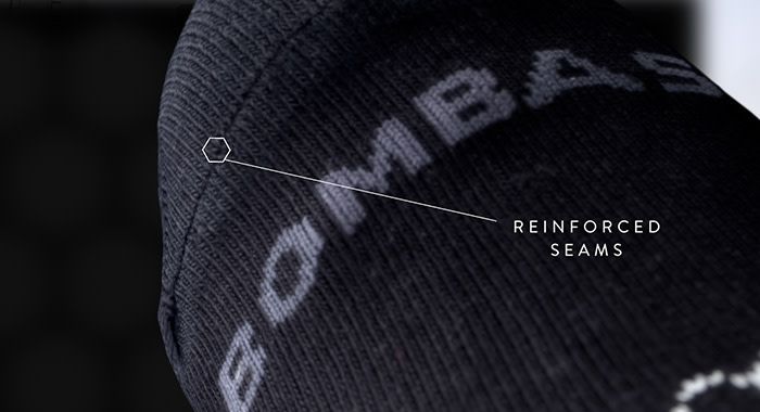 a close up detailed look at a sock with a circle and a line pointing at the seam on the sock and has a note, "reinforced Seams"