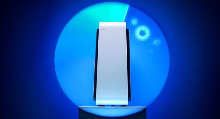 A upward shot of a blue air purifier on a pedestal with a blue circle rotating to kill germs