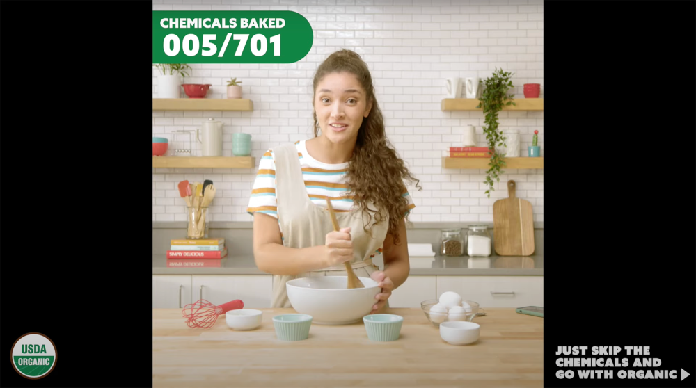 Woman in a kitchen stirring ingredients in a bowl with eggs and other ingredients surrounding the bowl on the kitchen counter