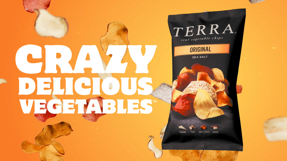 bag of terra chips floating in front of other airborne chips on a orange background with the words, "crazy delicious vegetables"