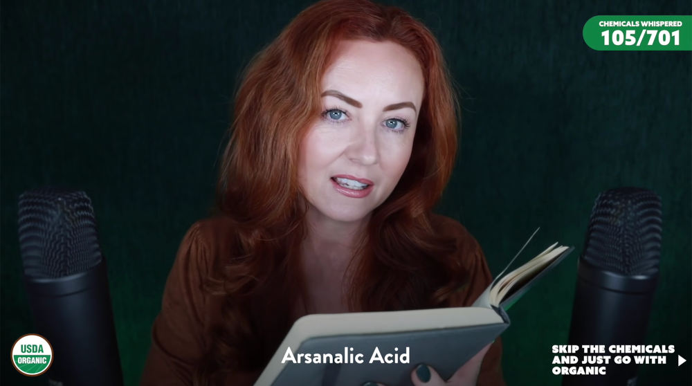 A woman being recorded by a webcam reading ingredients into a desktop microphone