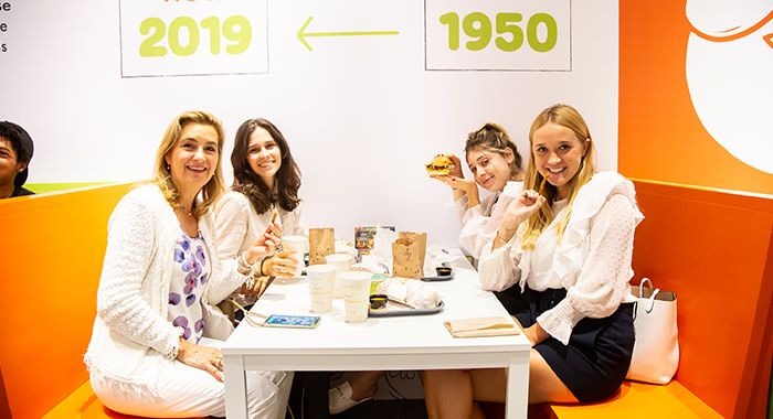 A shot of customers smiling and eating holy chicken