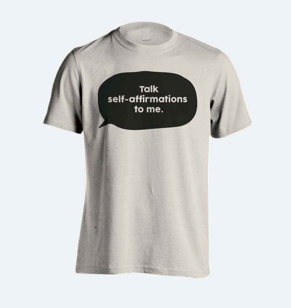 A picture of a shirt that has a speech bubble with the words, "Talk self-affirmations to me."