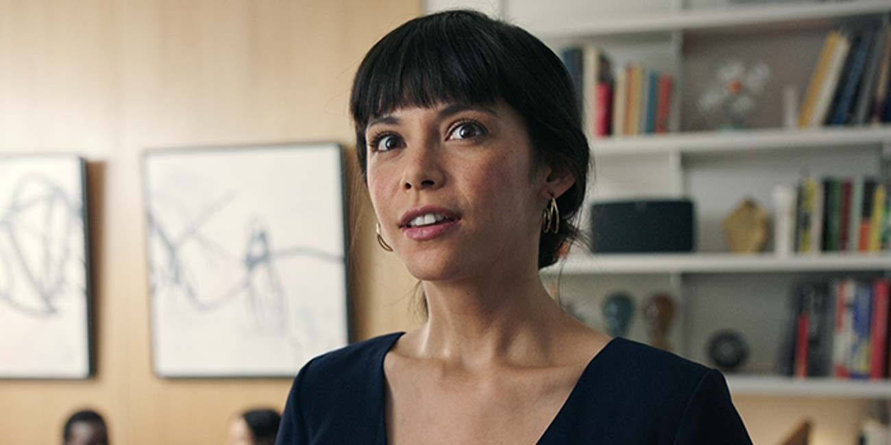 A close shot of a woman staring up while standing inside a home