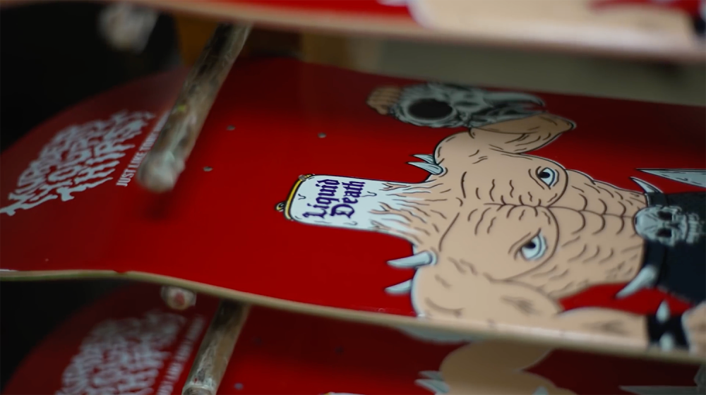 Close up shot of a rack of red skateboards with Tony Hawk's graphic on it