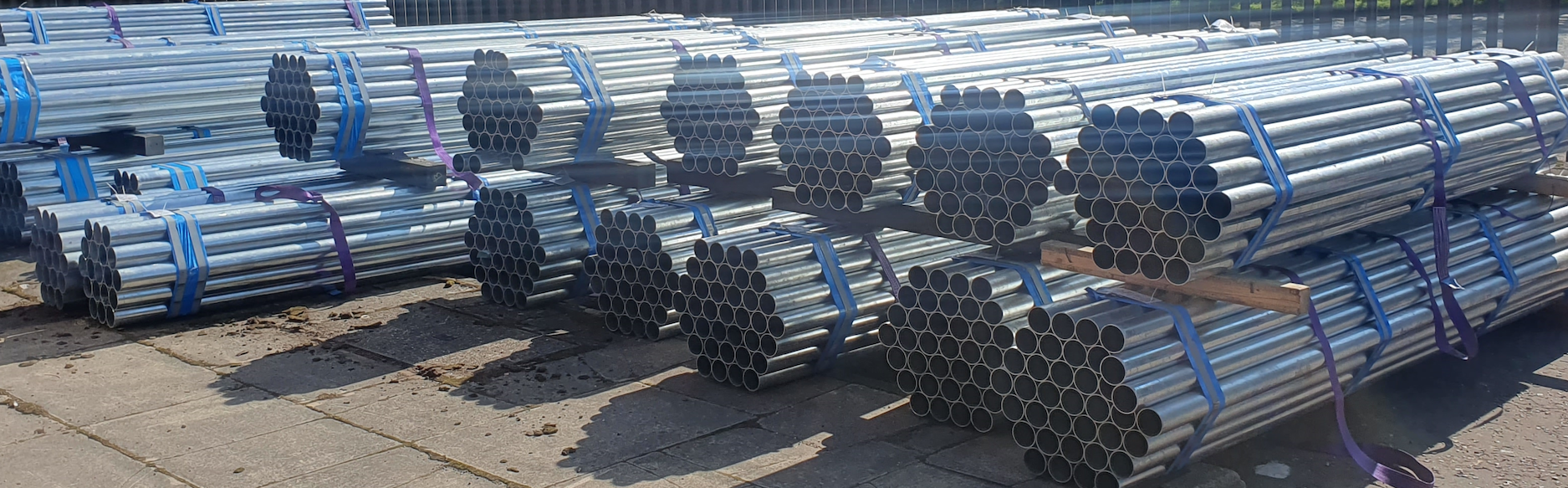 Road signs posts stored horizontally in bundles in wholesale storage
