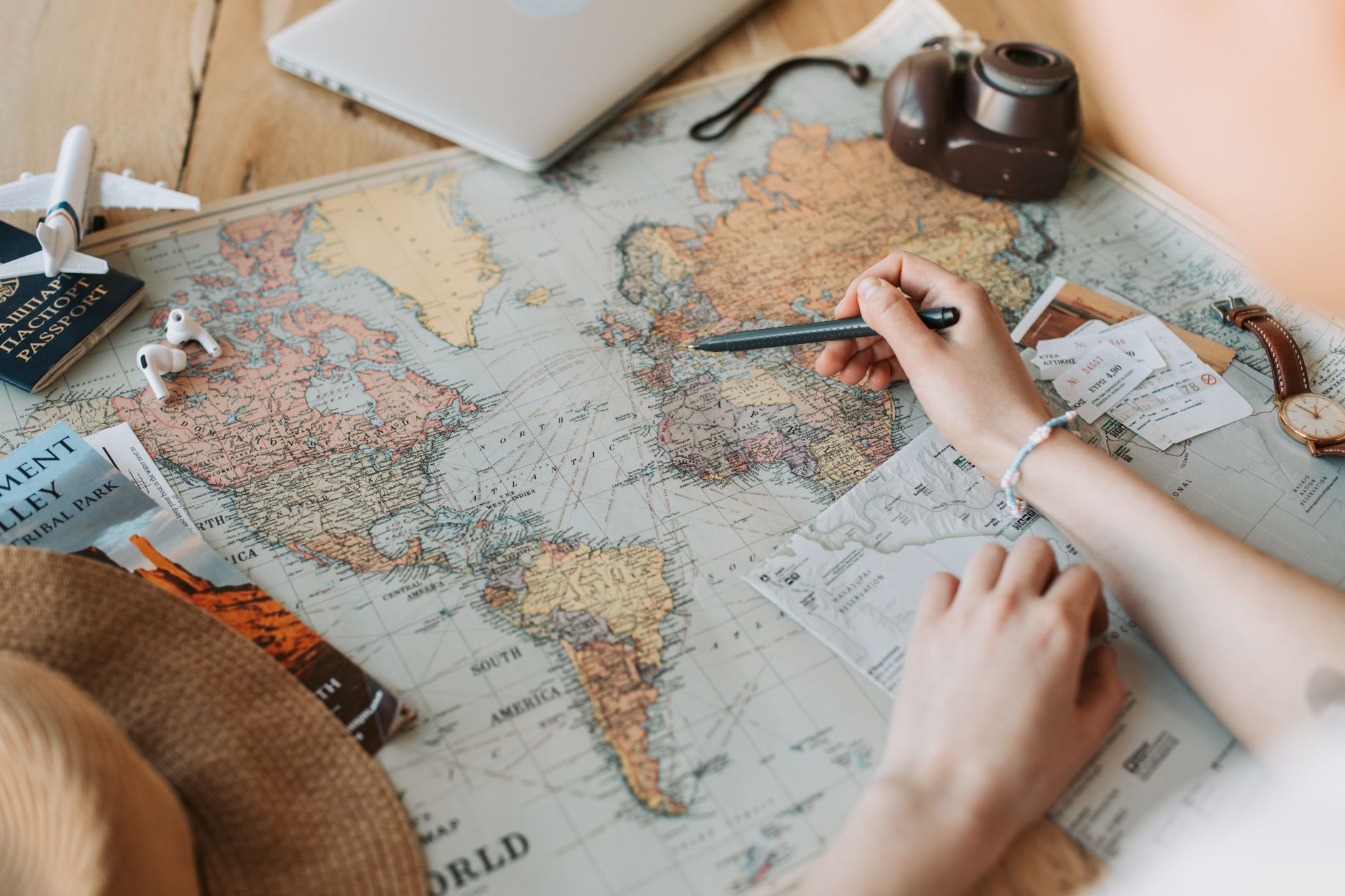 A world map surrounded by travel planning items