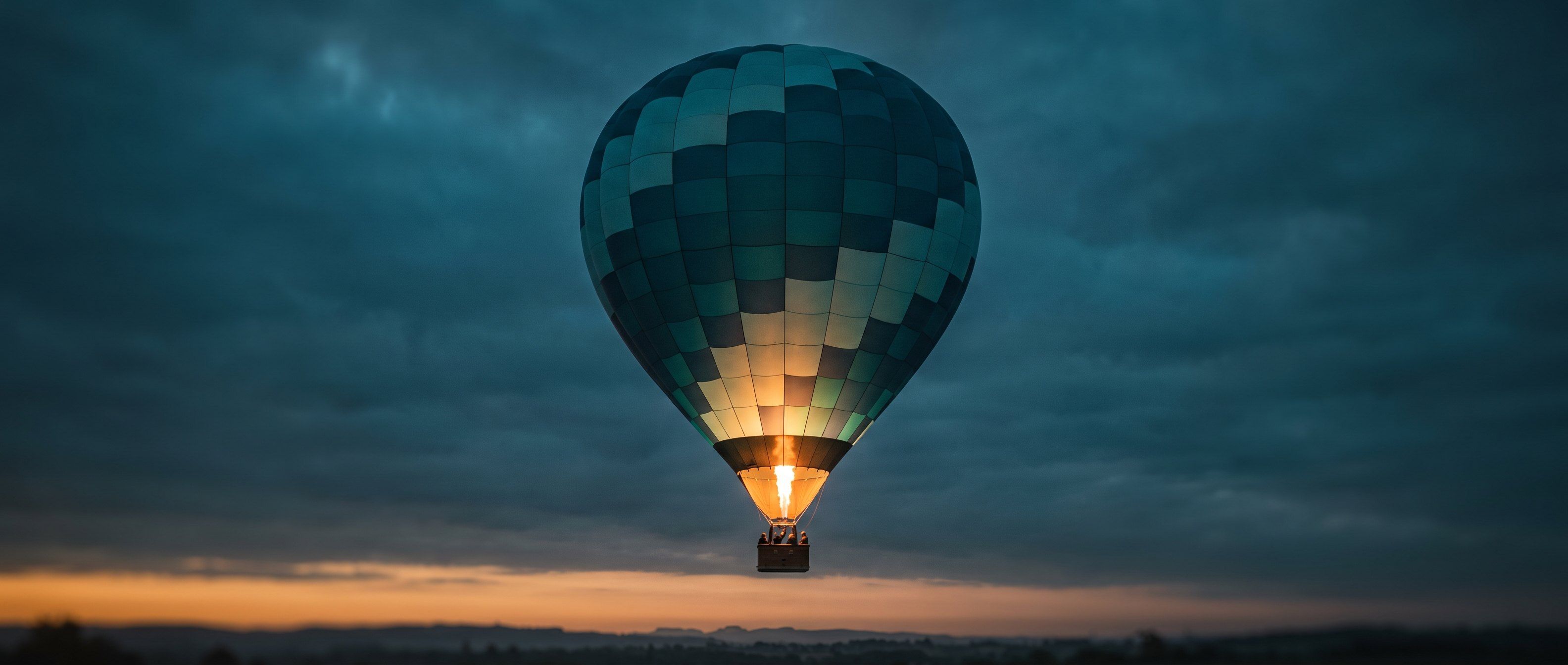 A single hot-air balloon rising steadily at dusk, lifted by a controlled amber burner flame against a deep teal sky - scaling on the fuel you feed it, under control.
