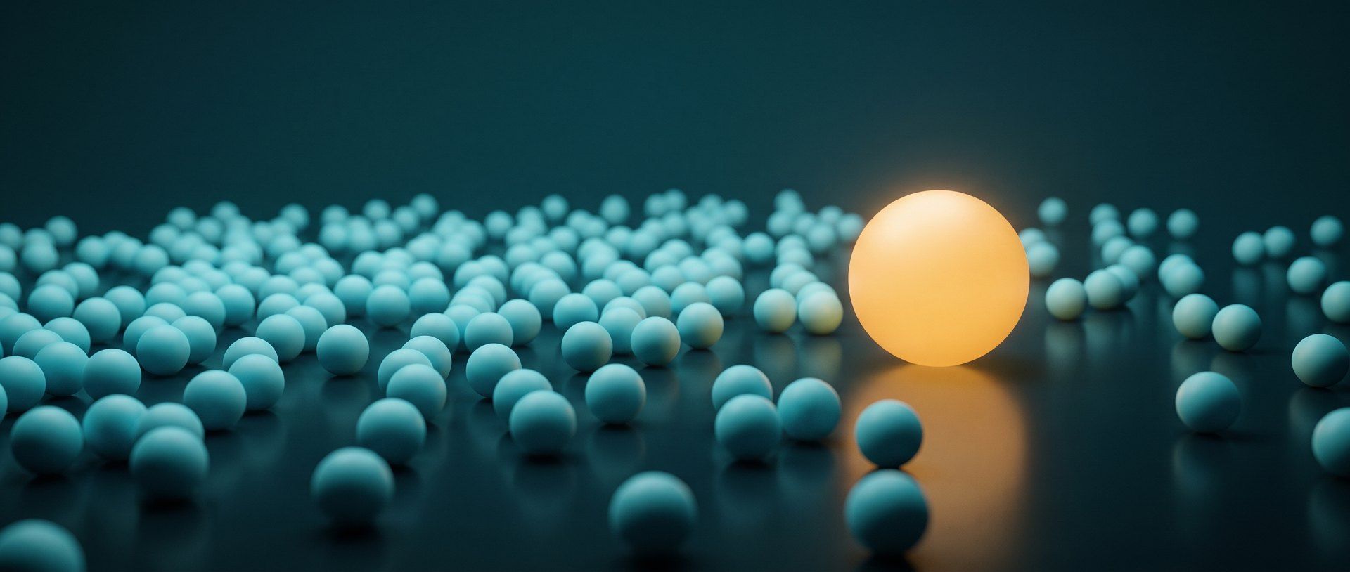 A field of small cool blue spheres on a dark surface, with one larger glowing warm amber sphere set apart from the rest.