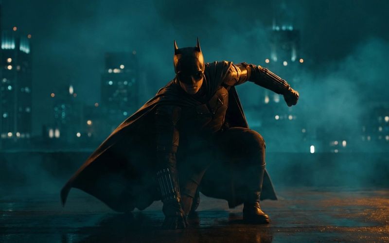 A caped superhero in a dramatic three-point landing pose on a rooftop at night - your landing page hero, sticking the landing.