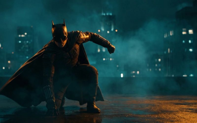 A caped superhero in a dramatic three-point landing pose on a rooftop at night - your landing page hero, sticking the landing.