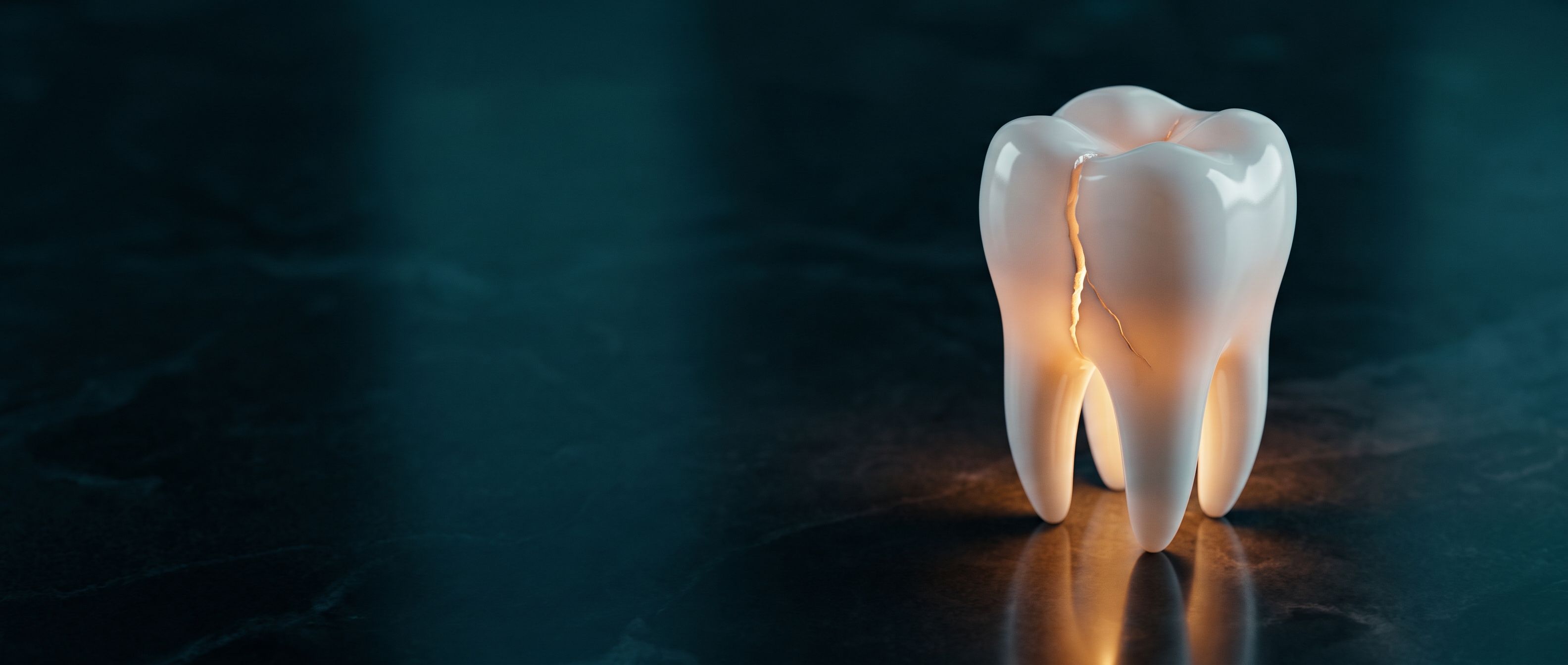 A white porcelain molar model with a glowing amber crack running down it