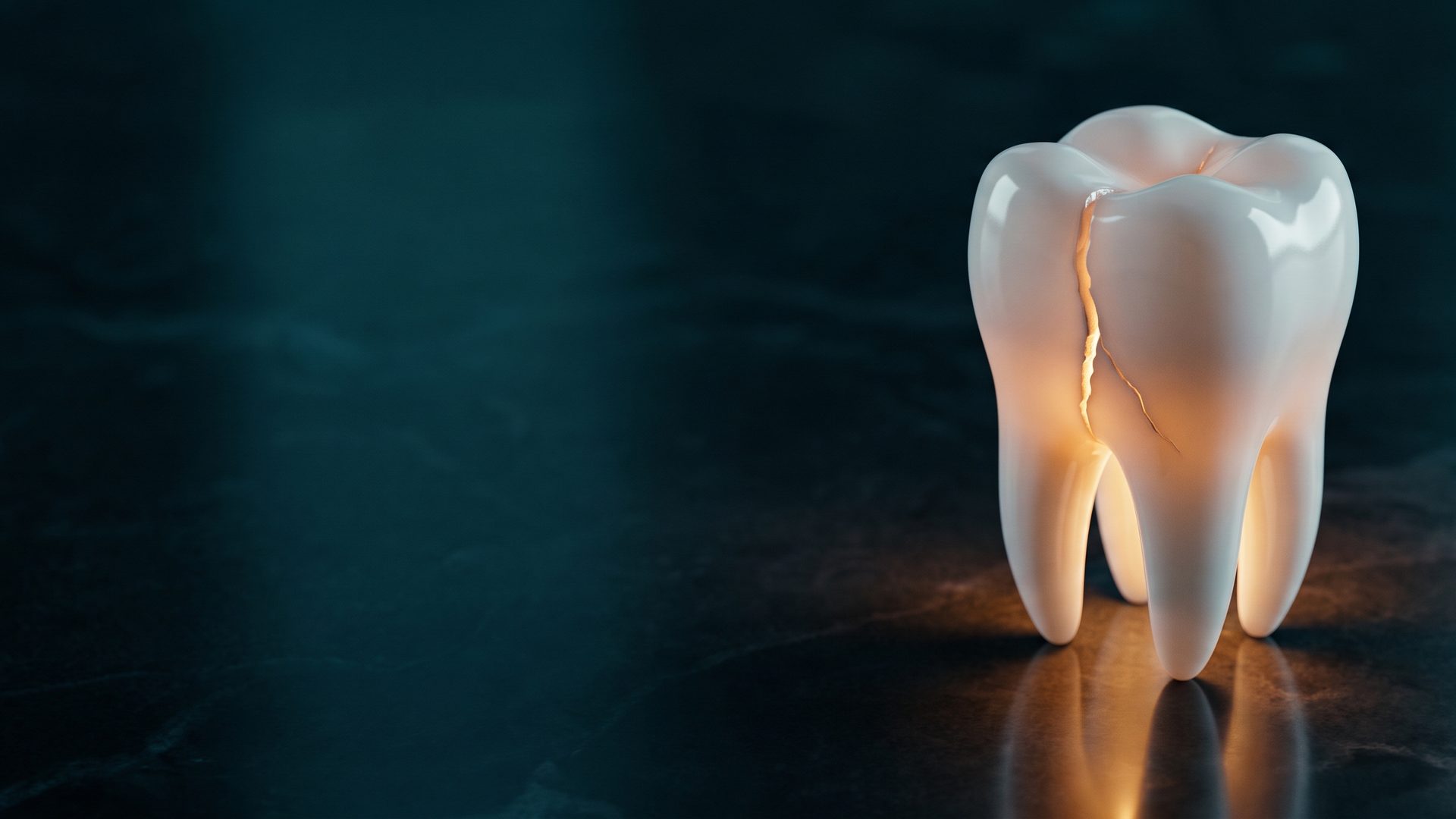 A white porcelain molar model with a glowing amber crack running down it