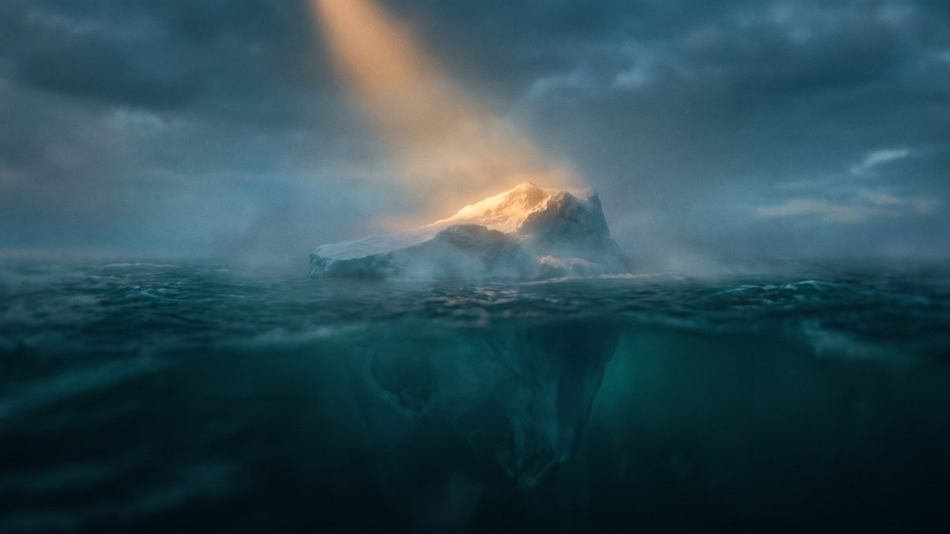 A lone iceberg at dusk, its small amber-lit tip above dark teal water and a vast shadowed mass hidden below the surface - the visible number versus the hidden reason your analytics can't show you.