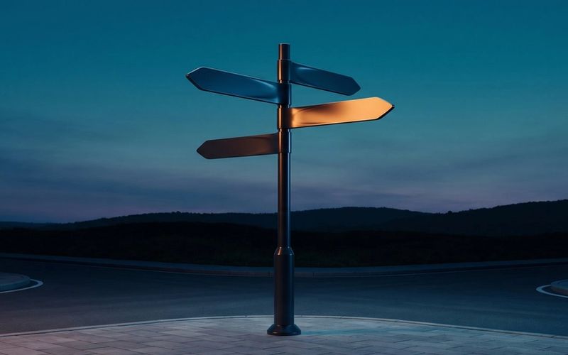 A lone directional signpost at dusk with one arm lit warm amber, pointing the way against a deep teal sky - a store's homepage routes shoppers to the right product.