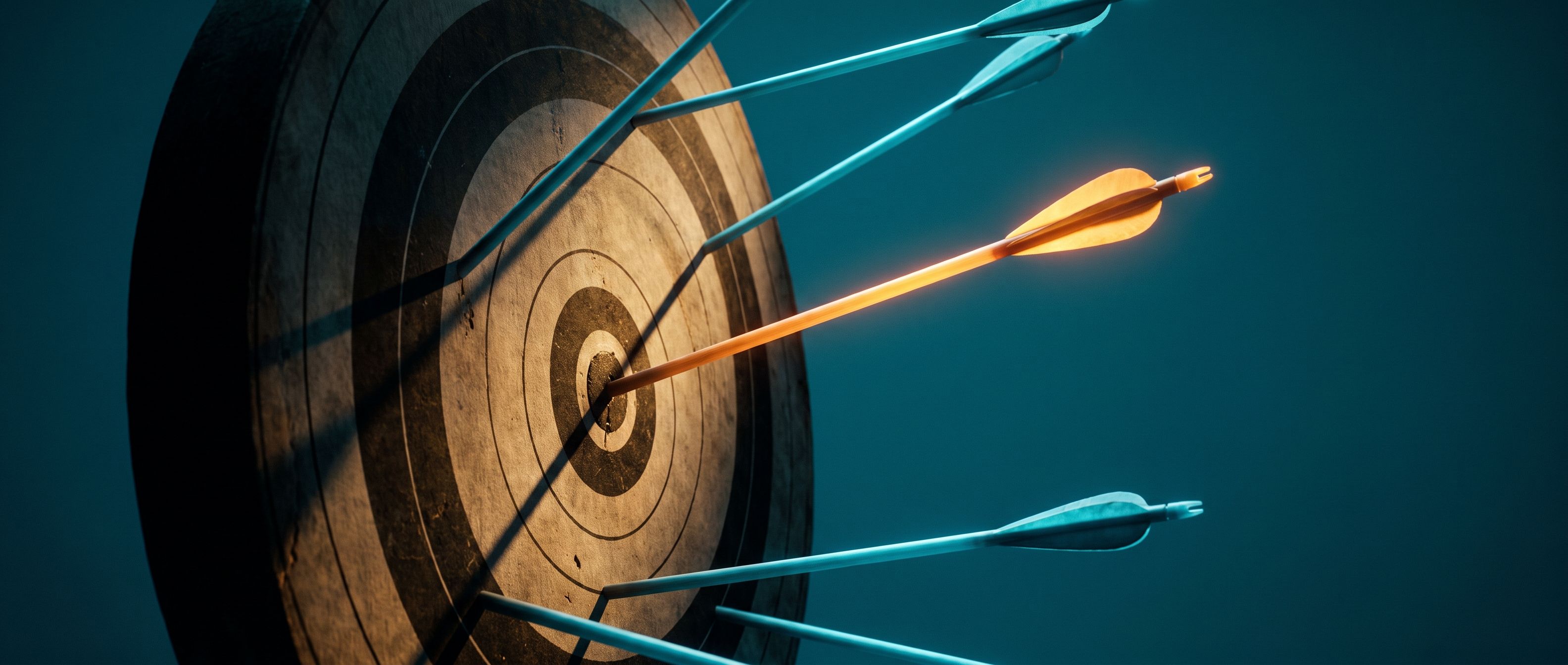 An amber arrow in the center of a bullseye while cool blue arrows miss