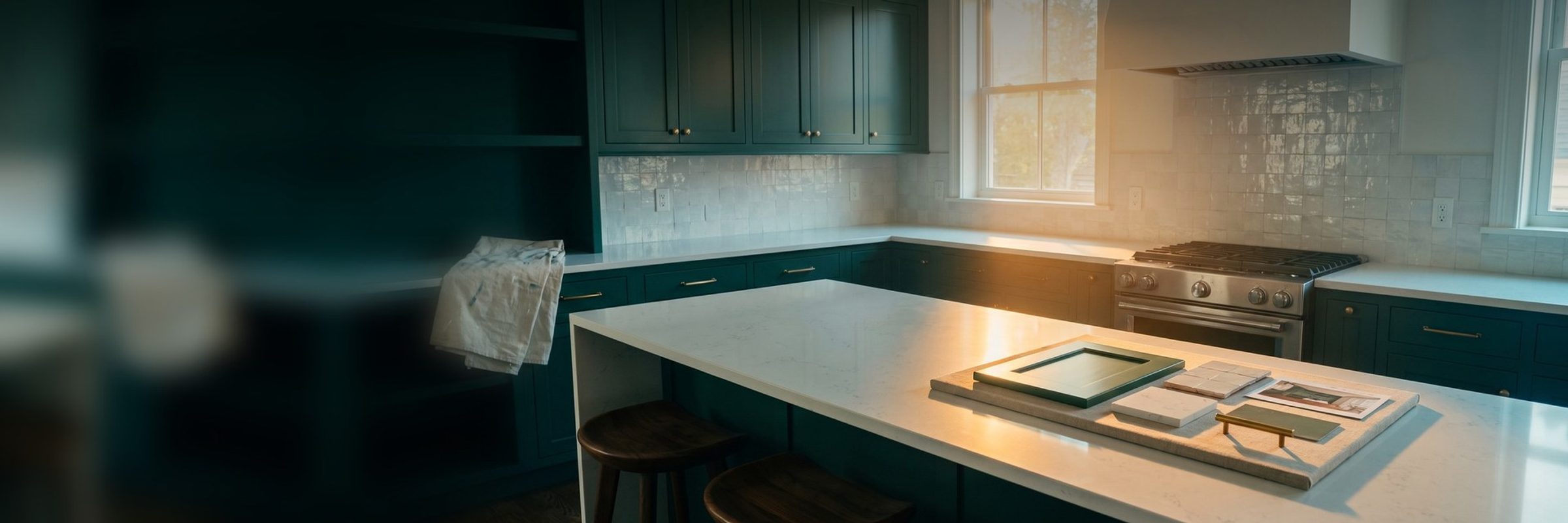 A just-finished kitchen with deep green shaker cabinets, white quartz counters and a zellige tile backsplash, with a design board on the island holding a matching cabinet-door sample, quartz chip, tile and brass pull