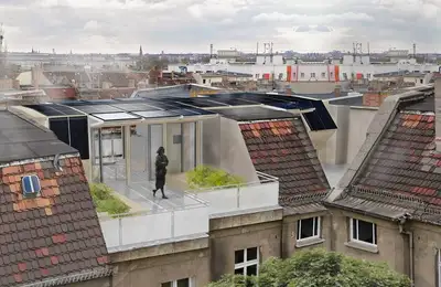 An Apartment Building in Berlin with a Solar Panel Roof