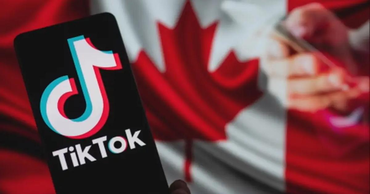 TikTok logo on a phone in front of a Canadian flag