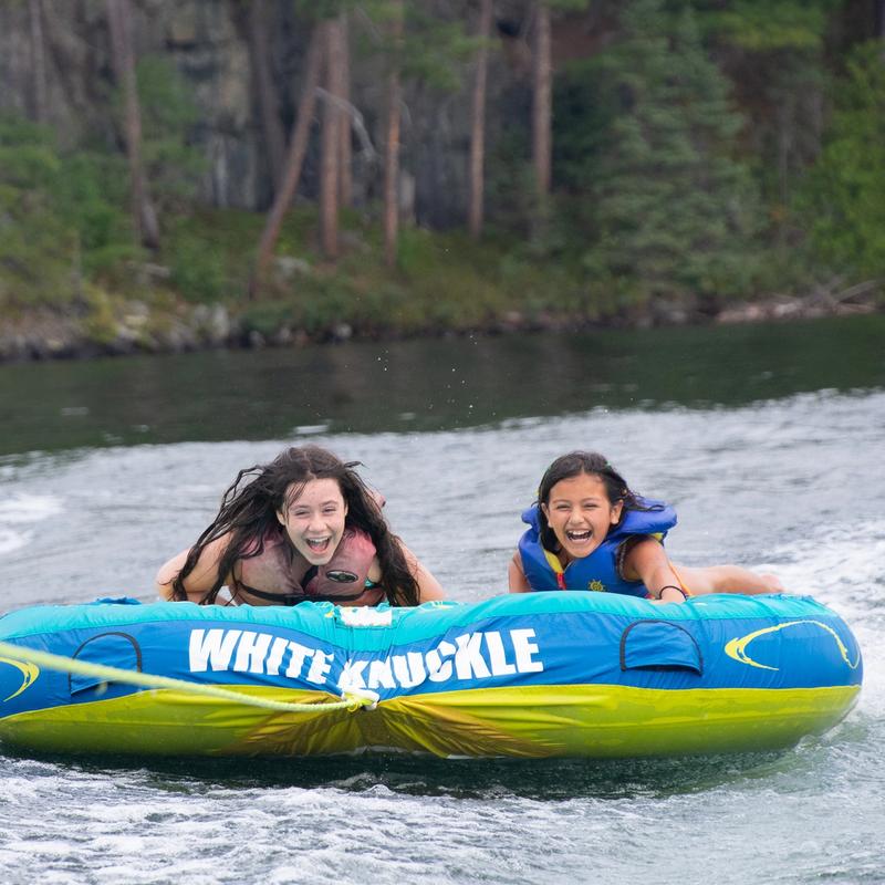 Campers tubing and smiling.