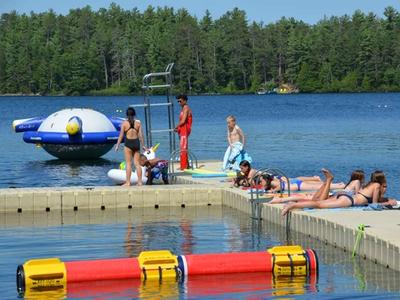 campers lying in the sun while lifeguard watches at Canadian Adventure Camp