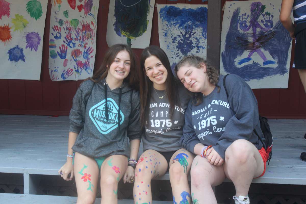 teenage campers with body paint smiling at the camera