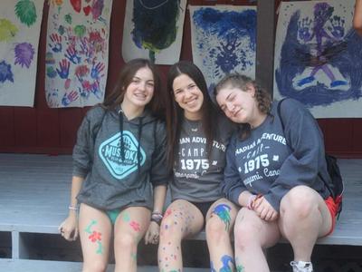teenage campers with body paint smiling at the camera