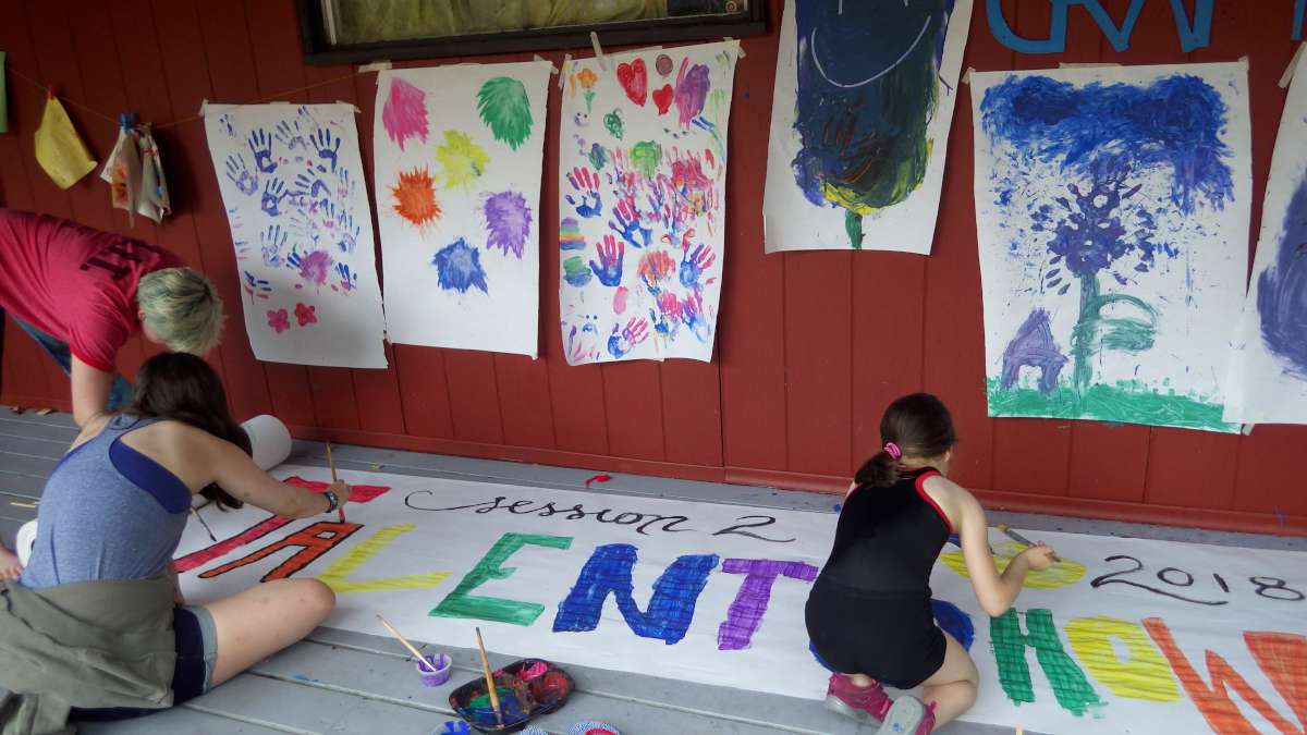 campers painting a giant poster together at Canadian Adventure Camp