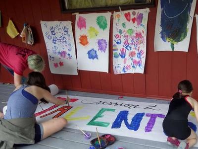 campers painting a giant poster together at Canadian Adventure Camp