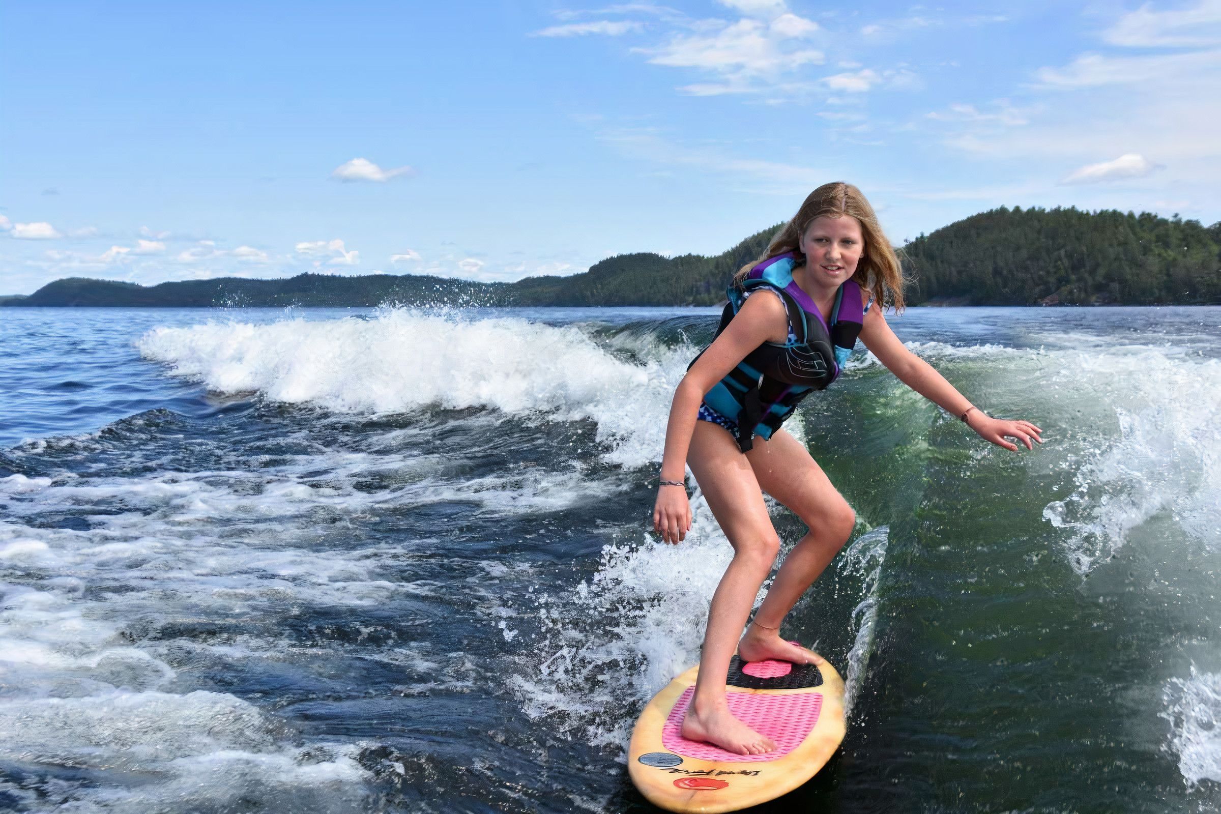 camper wakesurfing on the lake at Canadian Adventure Camp