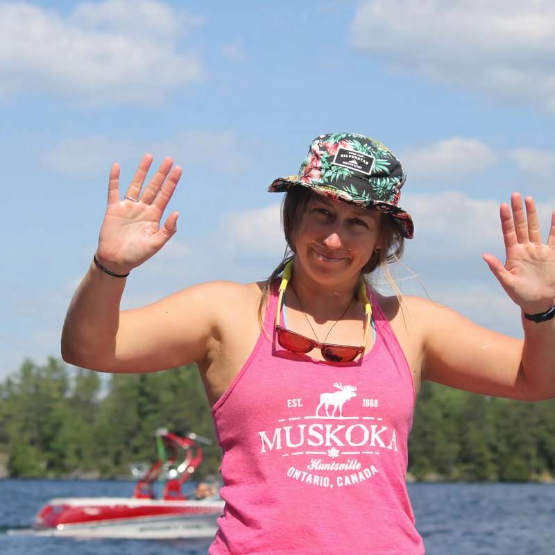 staff waving on the waterski docks during adult camp at Canadian Adventure Camp