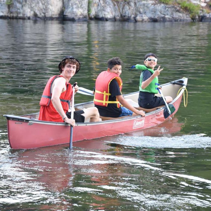 counsellor and campers canoeing at Canadian Adventure Camp