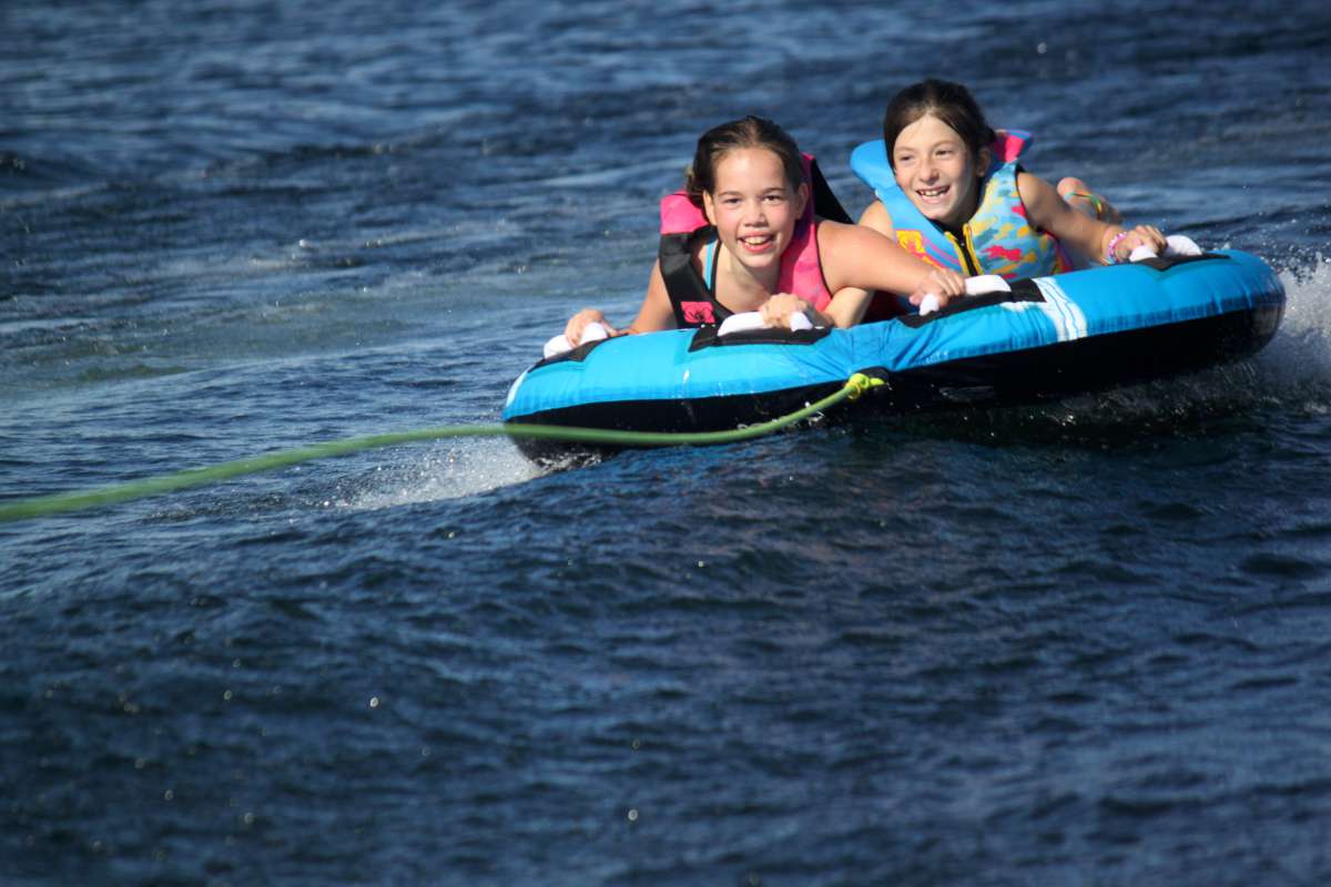 two young campers tubing on Lake Temagami at Canadian Adventure Camp