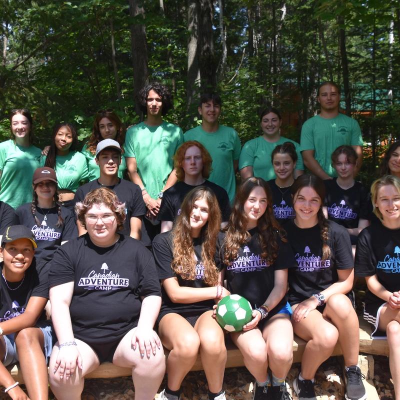 Group of teenage campers smiling at the camera.