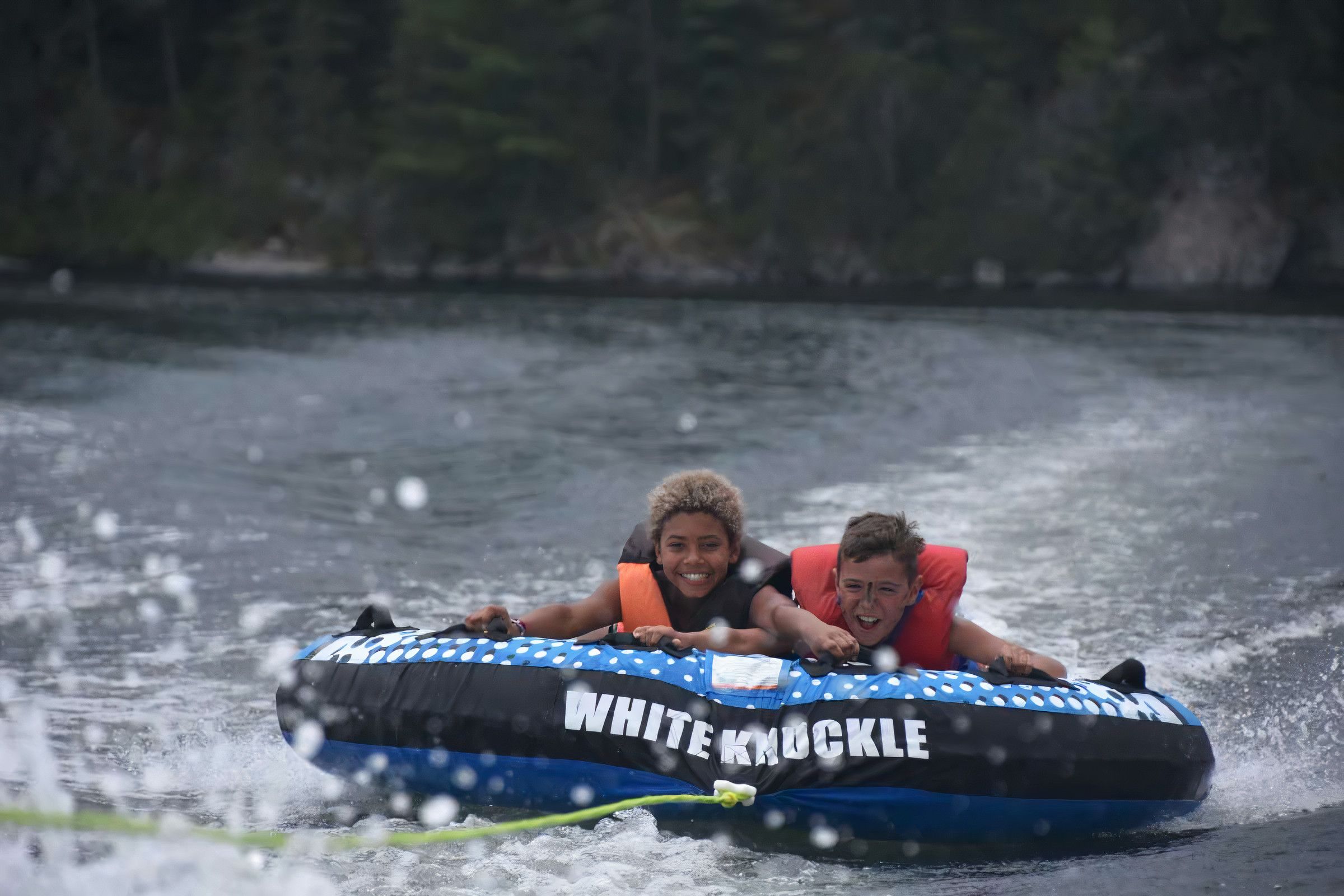 two campers smiling while tubing at Canadian Adventure Camp