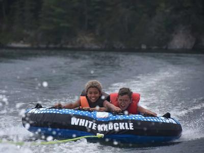 two campers smiling while tubing at Canadian Adventure Camp