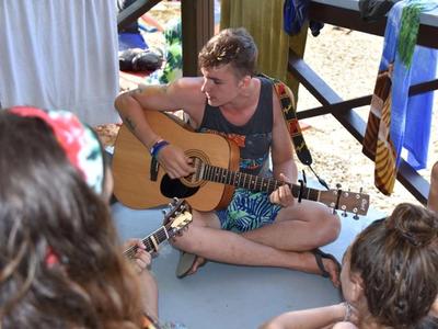 camp counsellor playing the guitar at Canadian Adventure Camp