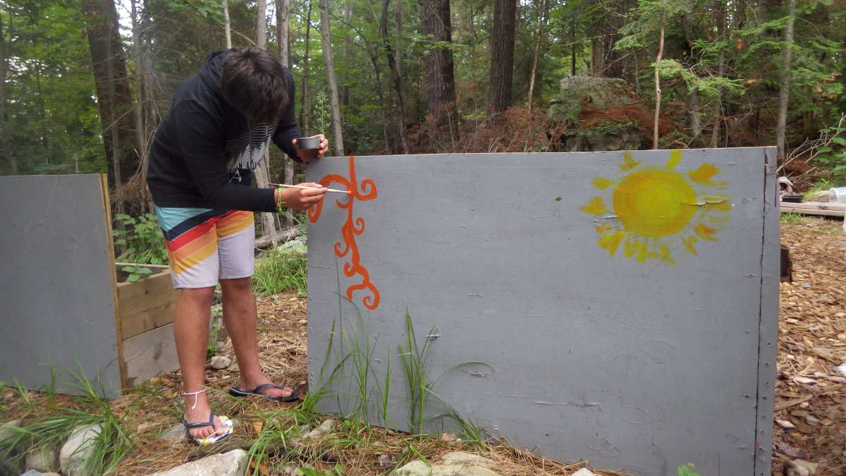 camper painting mural with sunshine