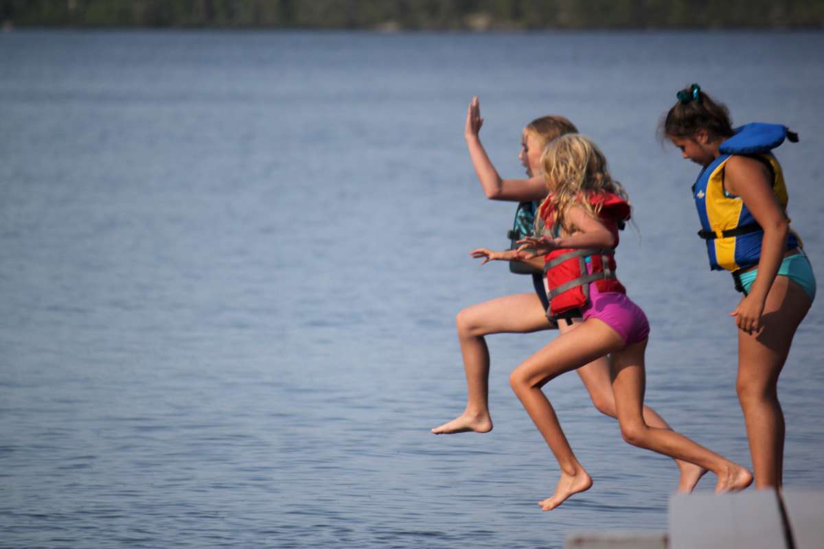 campers jumping into the lake at Canadian Adventure Camp