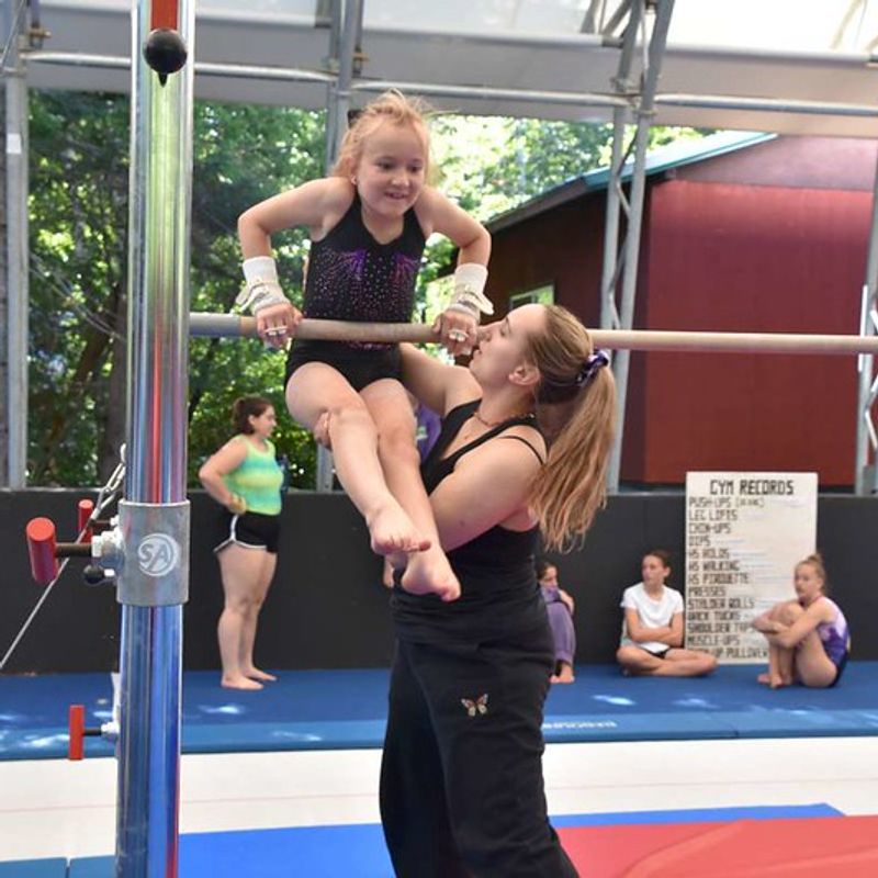 gymnastics coach training a camper at Canadian Adventure Camp