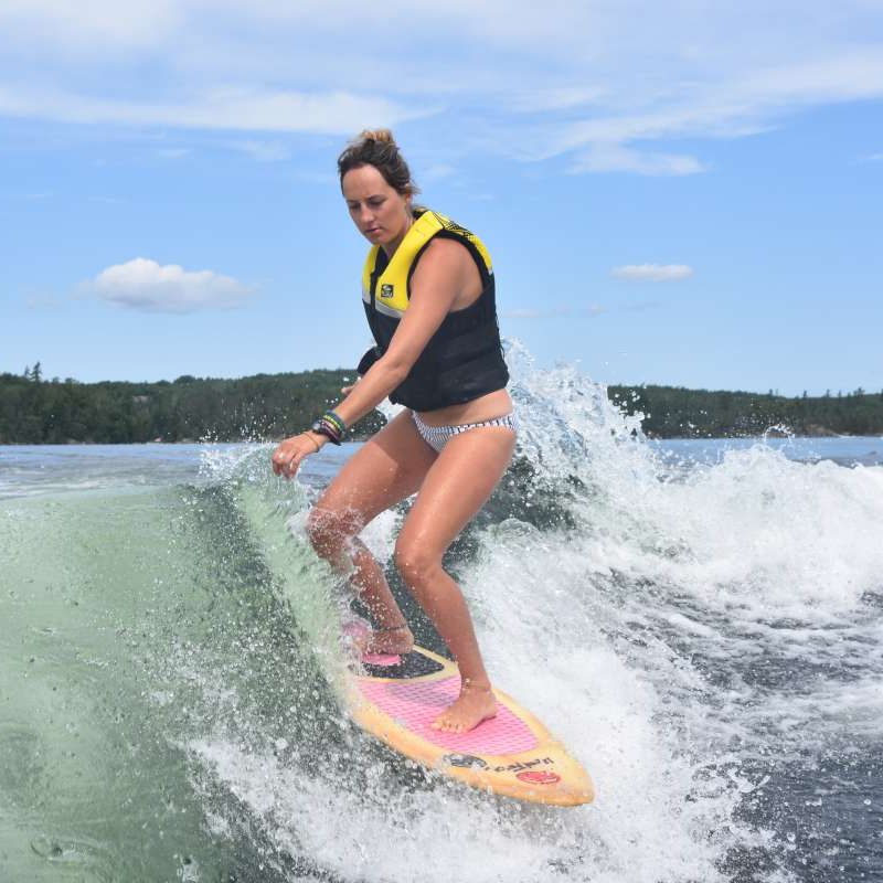 adult camper wakeboarding on the lake at Canadian Adventure Camp